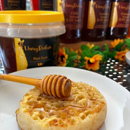 Crumpet drizzled with Red Gum honey and a honey dipper