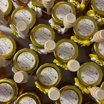 Rows of gold-lidded honey favour jars