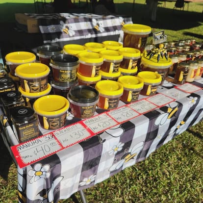 Honey tubs lined up on the market table
